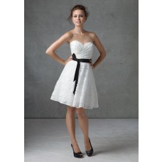A line strapless knee length short white lace dress with black sash